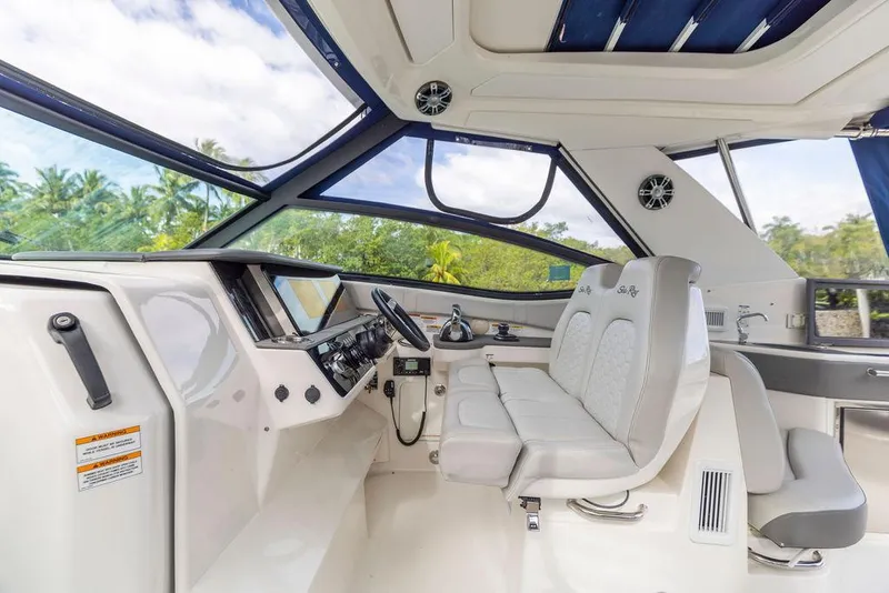 Slide: The Image of 2020 Sea Ray Sundancer 320 helm with modern controls and panoramic windows. - 21