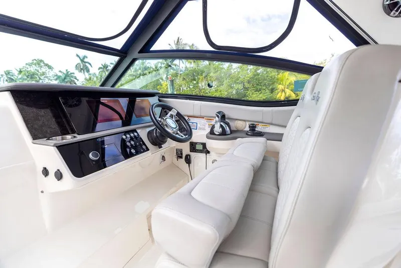 Slide: The Image of 2020 Sea Ray Sundancer 320 helm with modern controls and luxurious seating. - 22