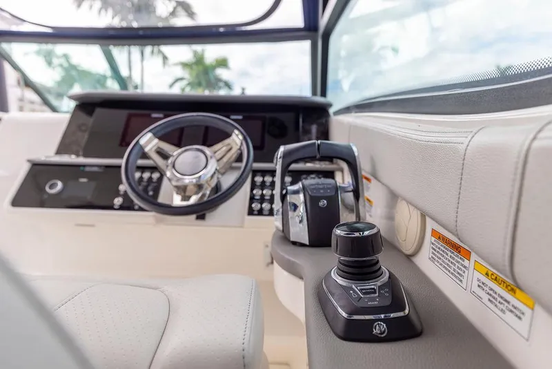 Slide: The Image of 2020 Sea Ray Sundancer 320 helm with steering wheel and control panel. - 23