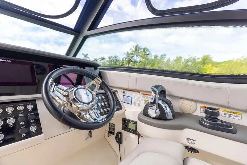 Slide: The Image of Cockpit of 2020 Sea Ray Sundancer 320 with modern controls and steering wheel. - 24
