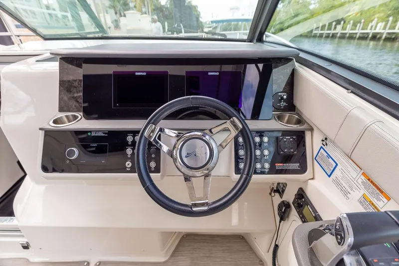 Slide: The Image of 2020 Sea Ray Sundancer 320 helm with modern controls and navigation displays. - 25