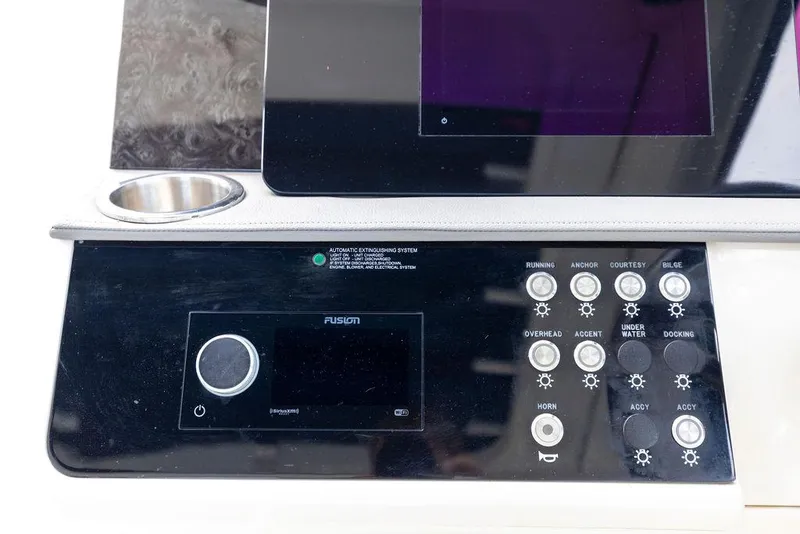 Slide: The Image of Control panel of a 2020 Sea Ray Sundancer 320 boat with various buttons and a display. - 28