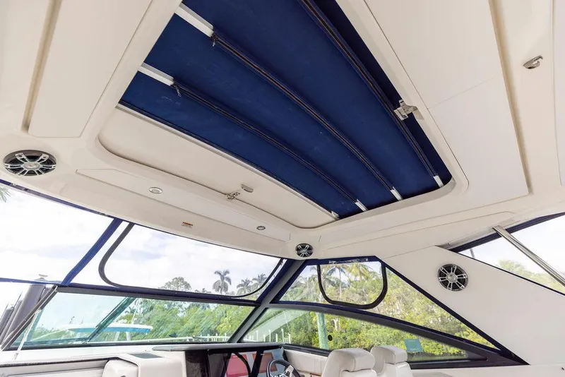 Slide: The Image of 2020 Sea Ray Sundancer 320 interior with blue retractable roof and panoramic windows. - 29