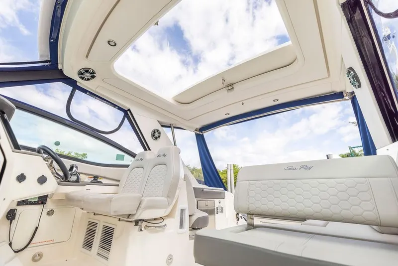 Slide: The Image of 2020 Sea Ray Sundancer 320 interior with plush seating and panoramic windows. - 31