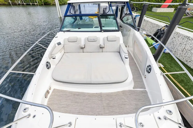 Slide: The Image of 2020 Sea Ray Sundancer 320 boat with spacious deck and comfortable seating by the water. - 35