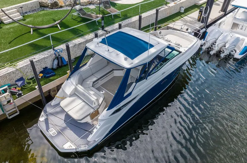 Slide: The Image of 2020 Sea Ray Sundancer 320 yacht docked, featuring sleek design and spacious seating. - 4
