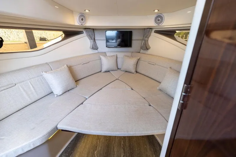 Slide: The Image of 2020 Sea Ray Sundancer 320 interior with plush seating and TV. - 41