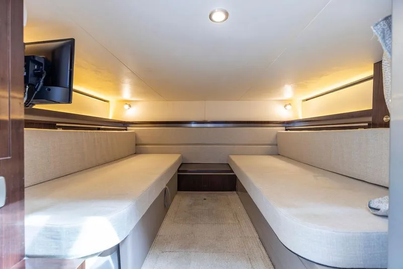 Slide: The Image of Interior cabin of 2020 Sea Ray Sundancer 320 with twin beige sofas and mounted TV. - 44