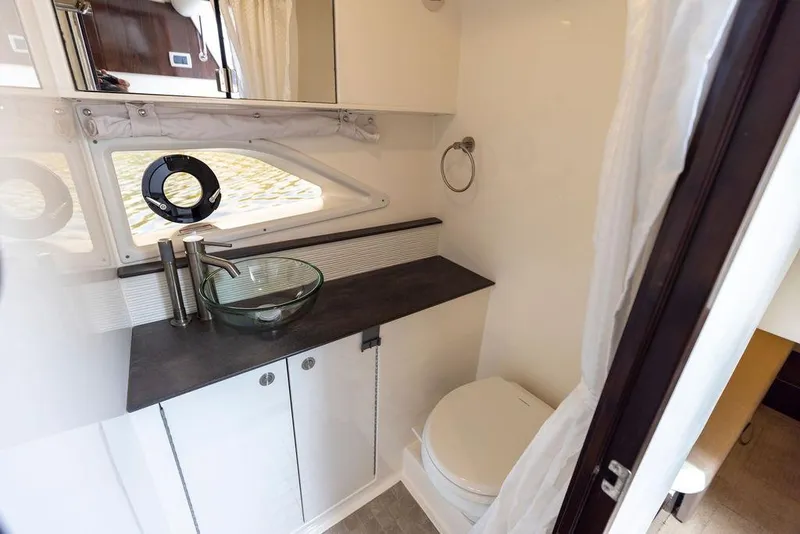 Slide: The Image of 2020 Sea Ray Sundancer 320 bathroom with modern sink and toilet. - 46