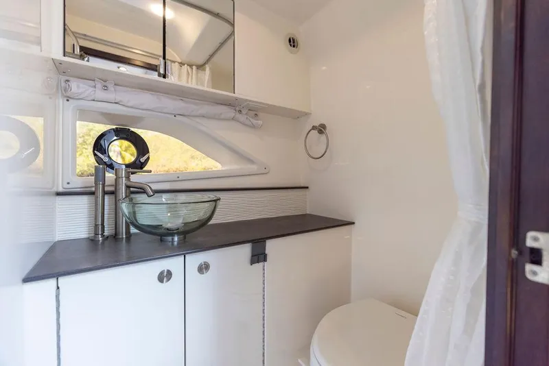 Slide: The Image of 2020 Sea Ray Sundancer 320 bathroom with modern sink and mirror. - 47