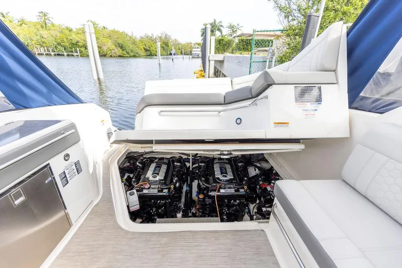 Slide: The Image of 2020 Sea Ray Sundancer 320 engine compartment, open view, docked by a scenic waterway. - 48