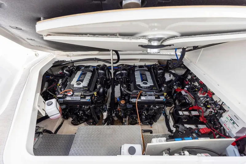 Slide: The Image of Engine compartment of 2020 Sea Ray Sundancer 320, showcasing dual engines and mechanical components. - 49