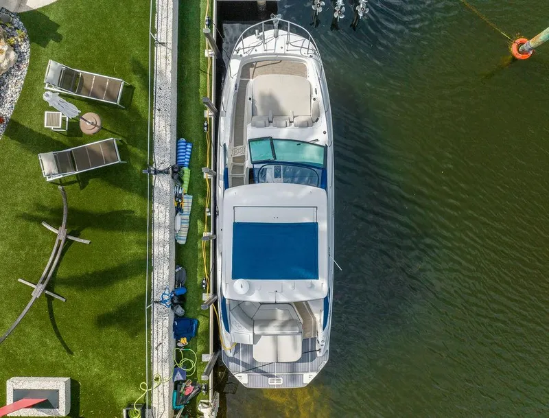 Slide: The Image of Overhead view of 2020 Sea Ray Sundancer 320 docked by a grassy area. - 5