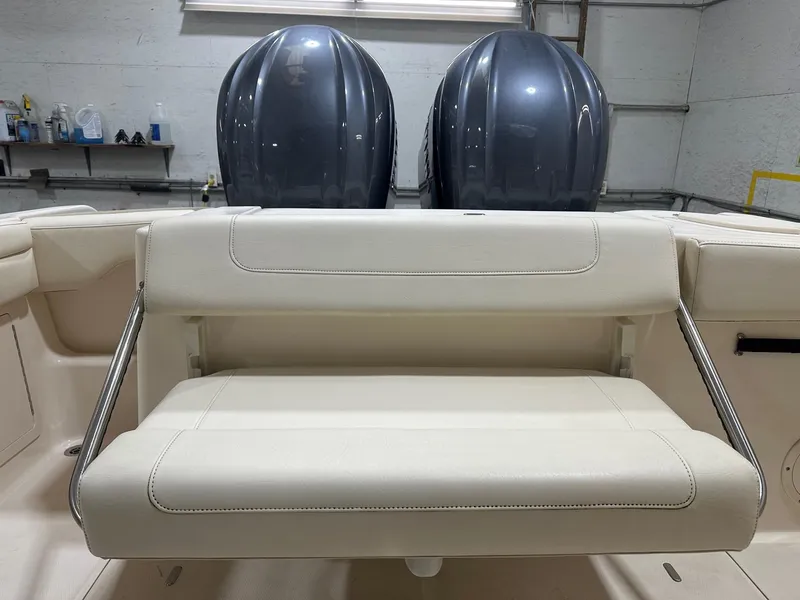 Slide: The Image of 2022 Grady-White Freedom 285 boat with dual engines and beige seating in a garage. - 10