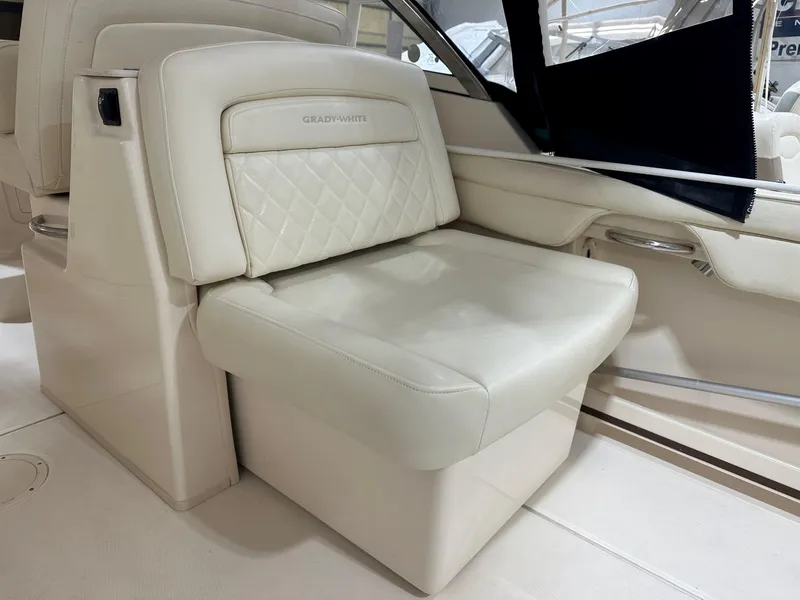 Slide: The Image of 2022 Grady-White Freedom 285 boat interior with luxurious cream seating. - 11