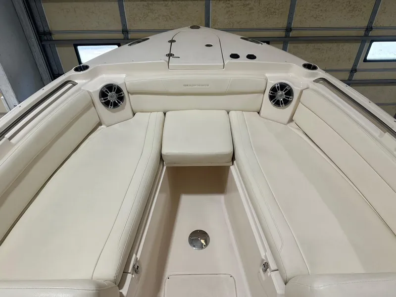 Slide: The Image of 2022 Grady-White Freedom 285 boat interior with cushioned seating and speakers. - 12