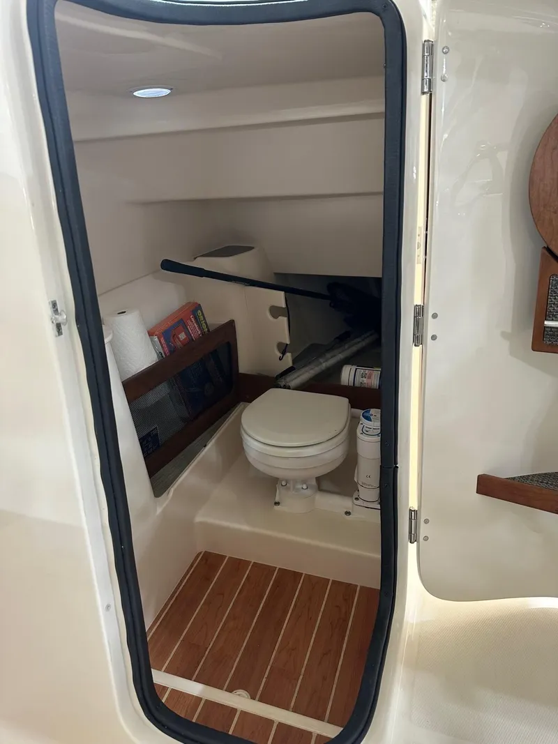 Slide: The Image of 2022 Grady-White Freedom 285 boat interior with toilet and storage area. - 6