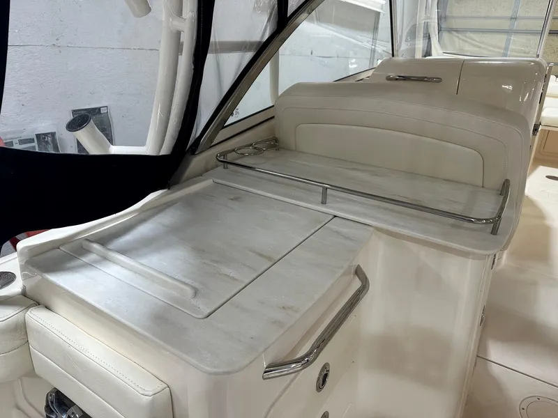 Slide: The Image of 2022 Grady-White Freedom 285 boat interior with sleek white seating and modern design. - 8