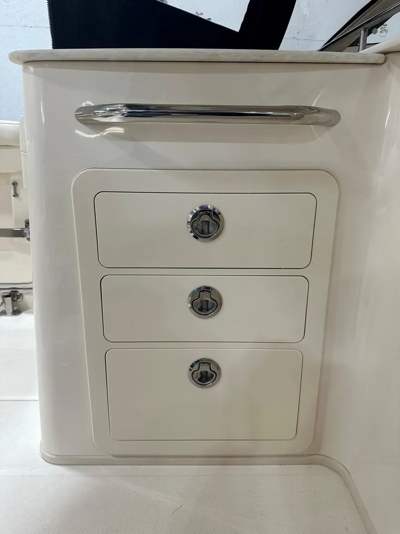 Slide: The Image of 2022 Grady-White Freedom 285 boat storage drawers with sleek handles. - 9