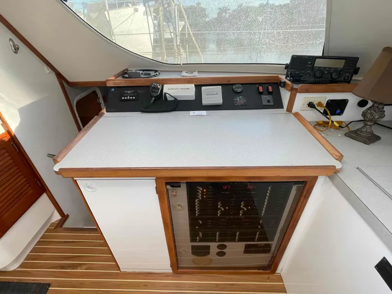 Slide: The Image of Control panel and storage area inside a 2000 Manta 42 Catamaran. - 18