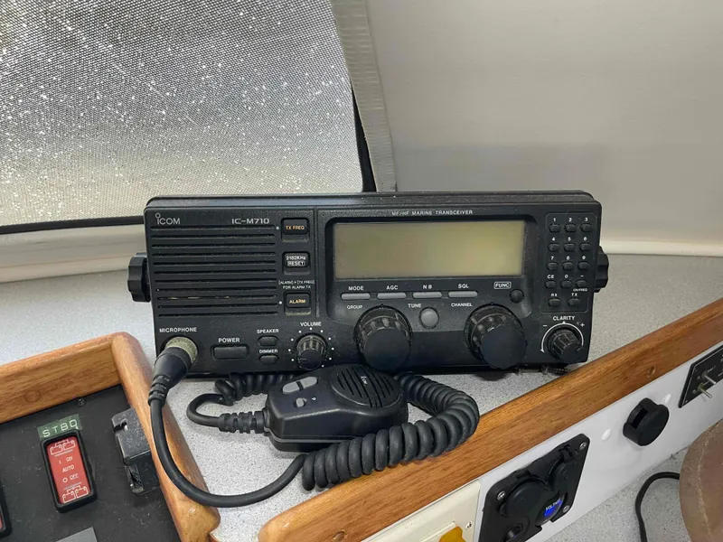 Slide: The Image of Marine radio equipment on a 2000 Manta 42 Catamaran, featuring an Icom IC-M710 transceiver. - 19