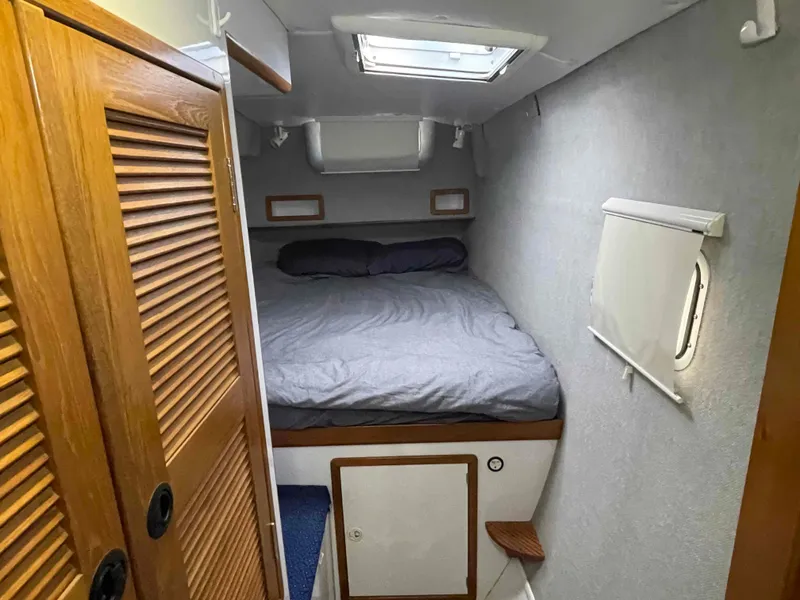 Slide: The Image of Cozy bedroom in 2000 Manta 42 Catamaran with skylight and wooden accents. - 25