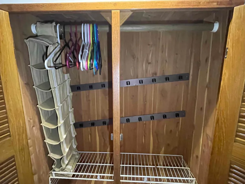 Slide: The Image of Wooden closet interior with hangers and storage, Manta 42 Catamaran, 2000 model. - 26