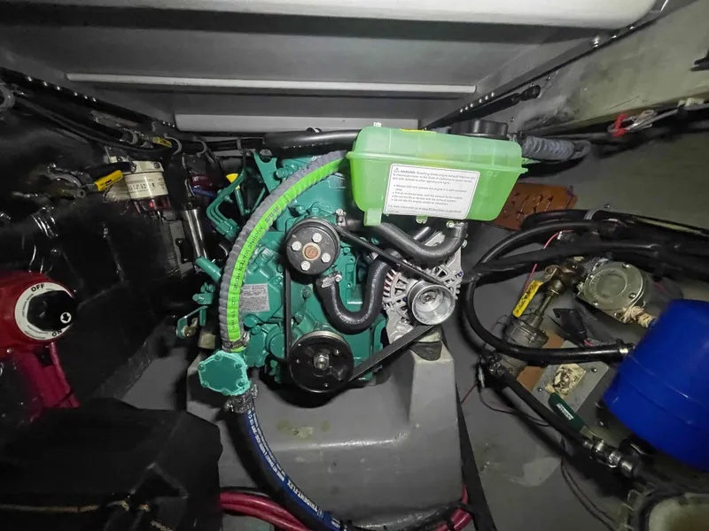 Slide: The Image of Engine compartment of a 2000 Manta 42 Catamaran, showcasing mechanical components and wiring. - 27