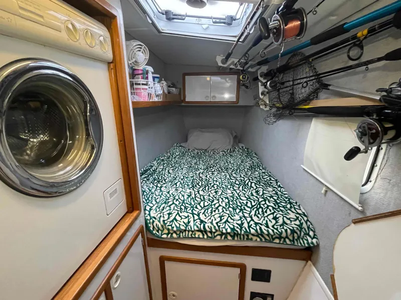 Slide: The Image of Compact cabin interior of 2000 Manta 42 Catamaran with bed and fishing gear. - 29