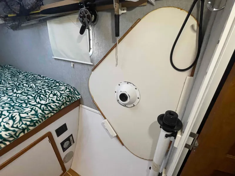 Slide: The Image of Interior of 2000 Manta 42 Catamaran with bed, storage, and nautical equipment. - 30