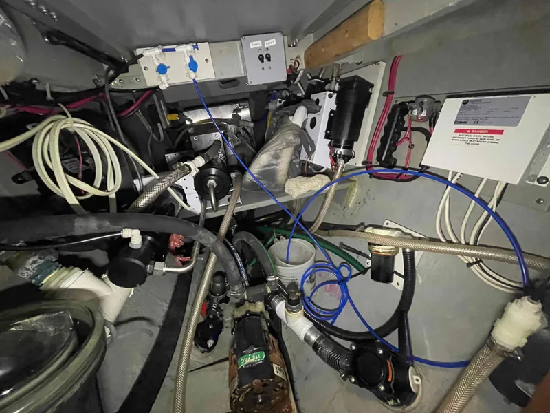 Slide: The Image of Engine room of 2000 Manta 42 Catamaran with complex wiring and mechanical components. - 32