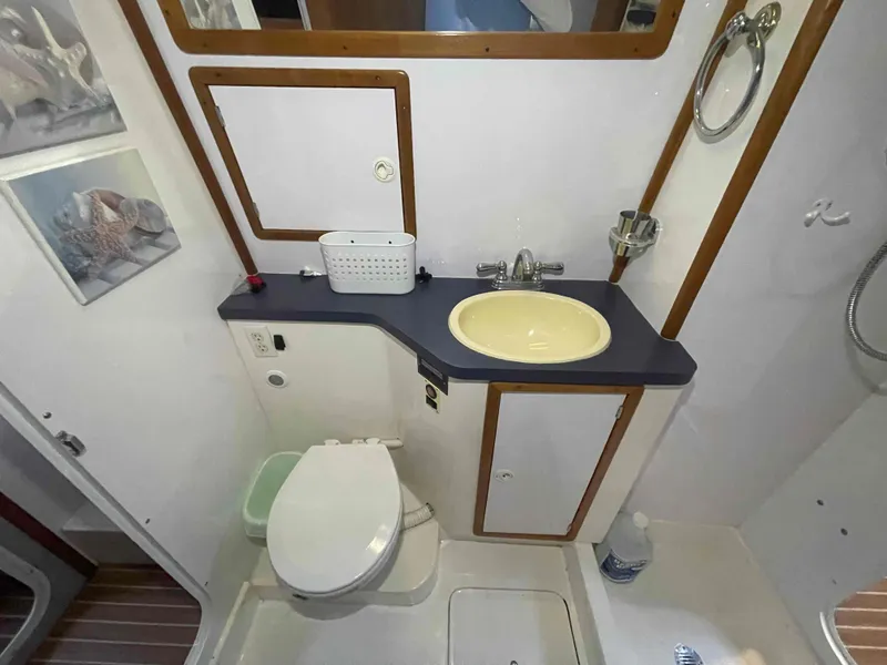 Slide: The Image of Bathroom interior of 2000 Manta 42 Catamaran with sink, toilet, and mirror. - 33