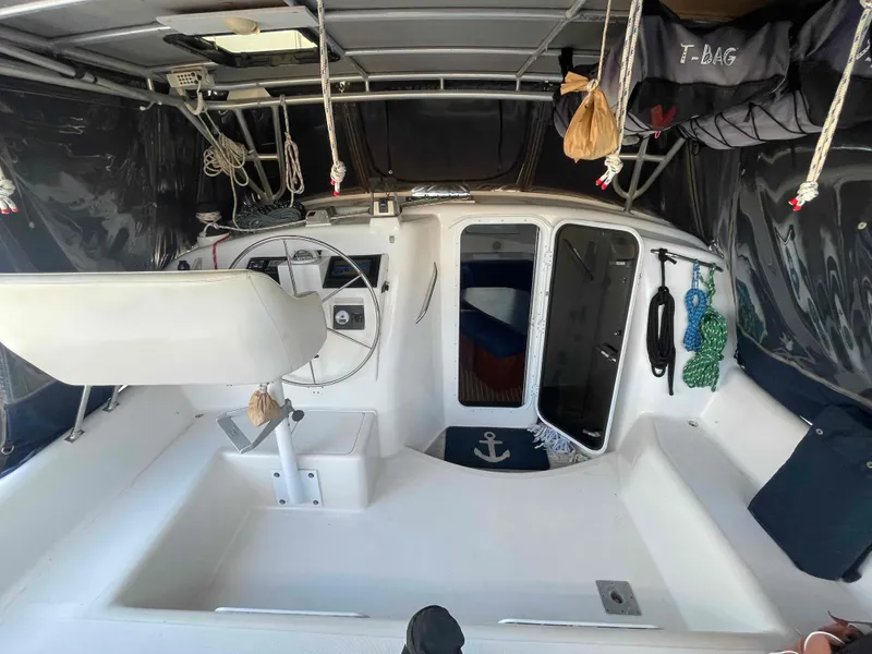 Slide: The Image of Interior of 2000 Manta 42 Catamaran with steering wheel and nautical decor. - 34