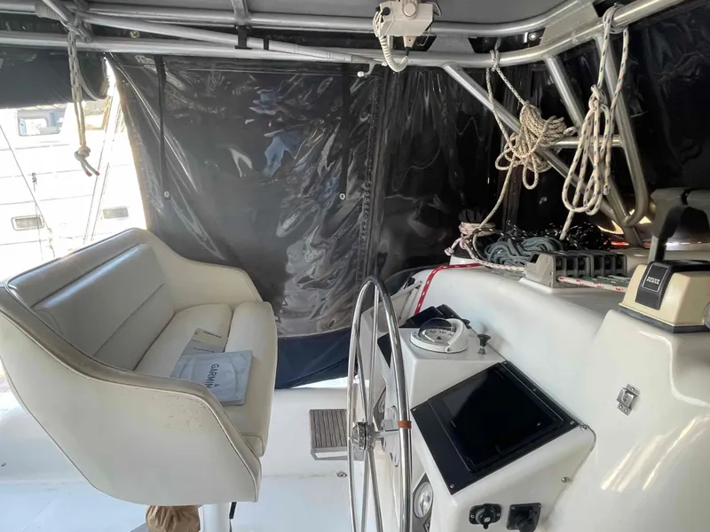Slide: The Image of 2000 Manta 42 Catamaran cockpit with steering wheel, navigation equipment, and seating. - 35