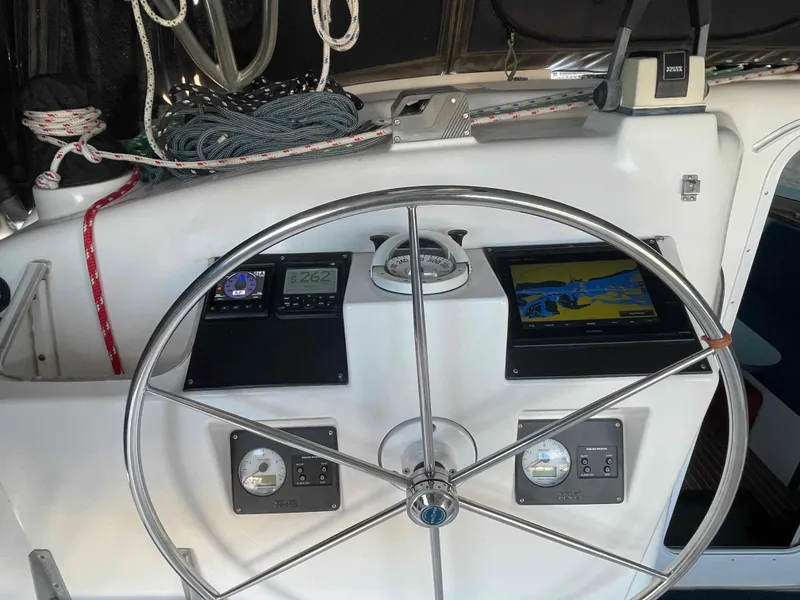 Slide: The Image of Steering wheel and navigation instruments on 2000 Manta 42 Catamaran. - 36