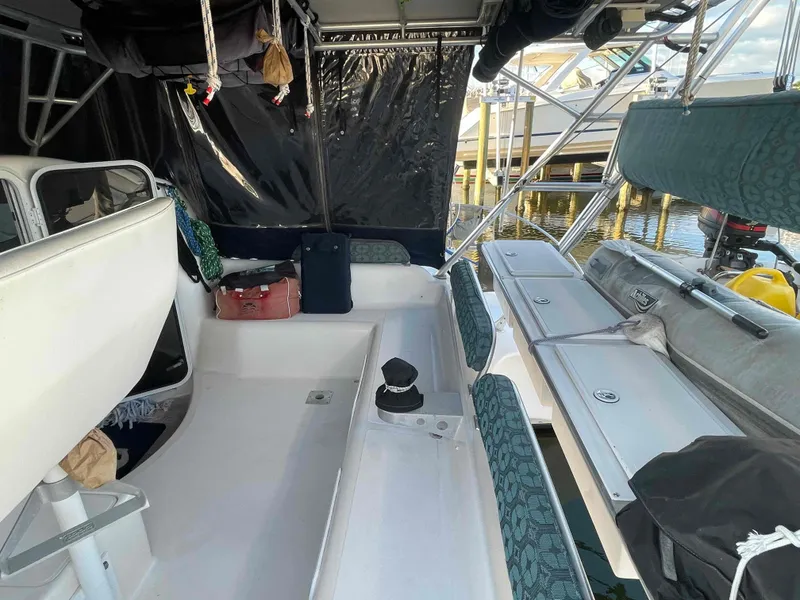 Slide: The Image of 2000 Manta 42 Catamaran interior with seating and storage, docked at marina. - 44