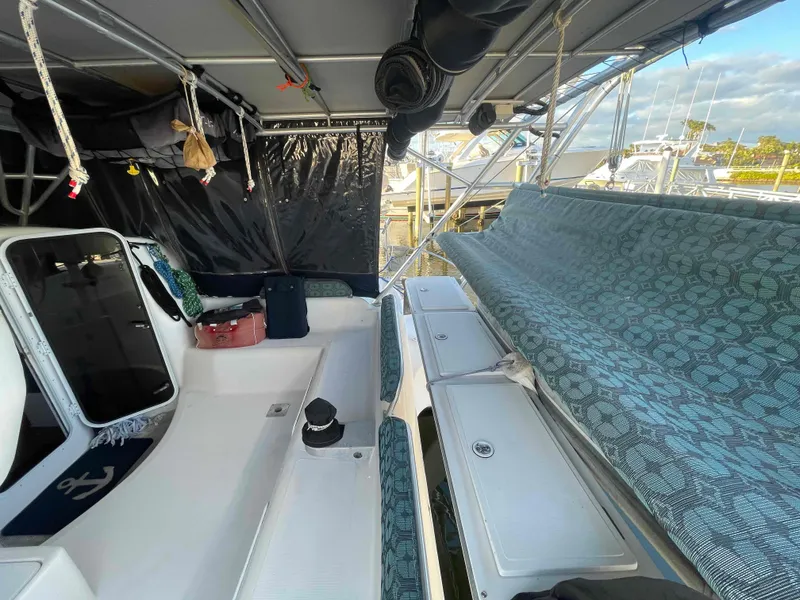 Slide: The Image of 2000 Manta 42 Catamaran interior with seating and storage, docked at marina. - 45