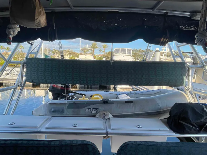 Slide: The Image of Manta 42 Catamaran 2000 with dinghy at marina, view from cockpit. - 48