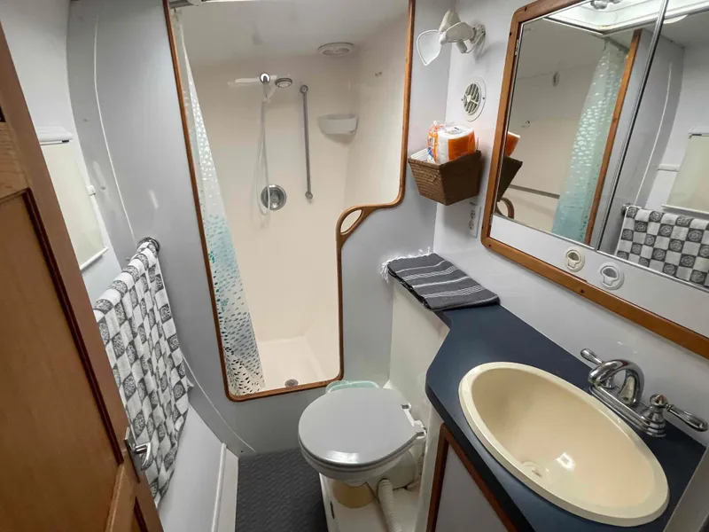 Slide: The Image of Bathroom interior of 2000 Manta 42 Catamaran with shower, sink, and toilet. - 8