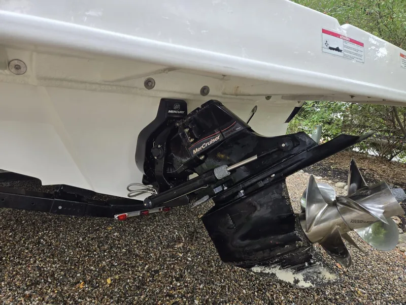 Slide: The Image of 2015 Sea Ray 220 Sundeck boat with MerCruiser outdrive on gravel surface. - 19