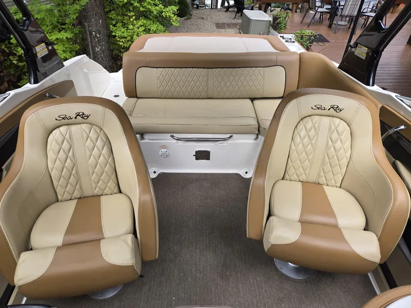 Slide: The Image of 2015 Sea Ray 220 Sundeck interior with beige and brown seating, featuring quilted design. - 6