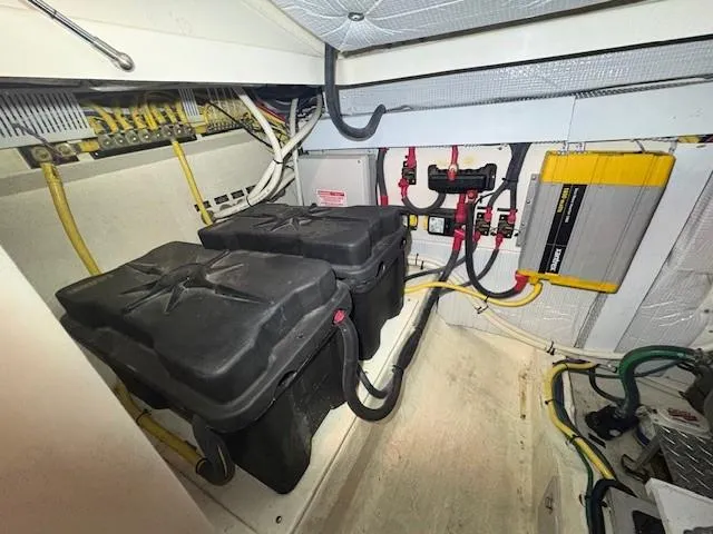 Slide: The Image of Battery compartment of a 2013 Back Cove 34 boat, featuring wiring and electrical components. - 11