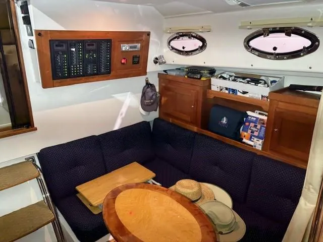 Slide: The Image of Interior of 2013 Back Cove 34 boat with seating, table, and control panel. - 12