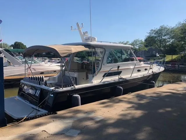 Slide: The Image of 2013 Back Cove 34 boat docked at a marina under clear skies. - 6