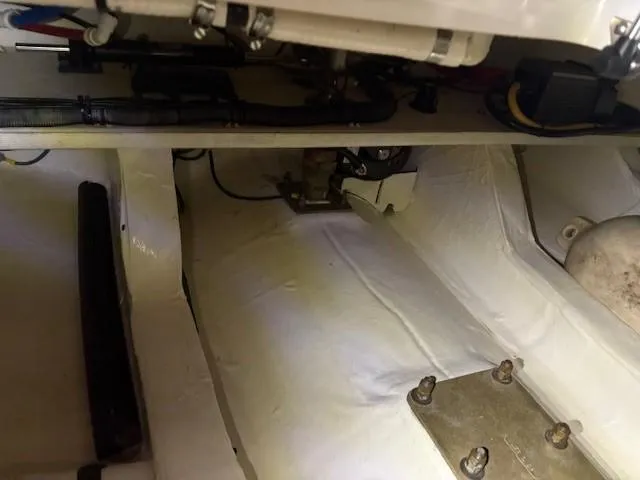 Slide: The Image of Engine compartment of a 2013 Back Cove 34 boat, showing mechanical components and wiring. - 9