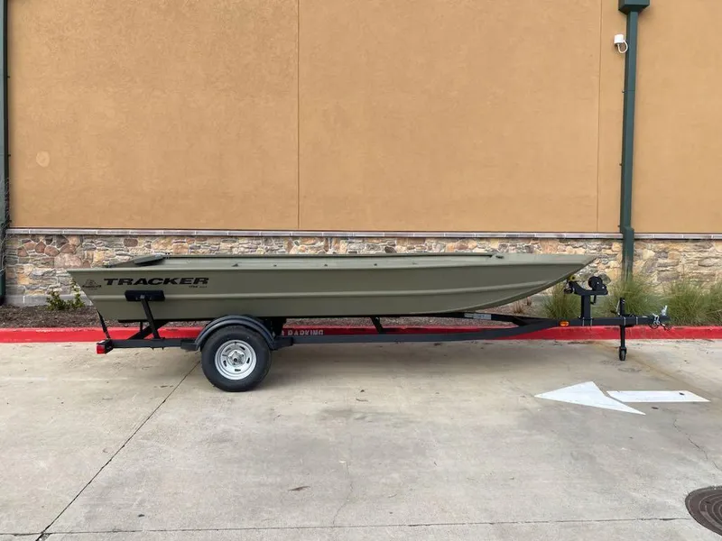 Slide: The Image of 2025 Tracker Grizzly 1754 Jon boat on trailer, parked outdoors. - 2