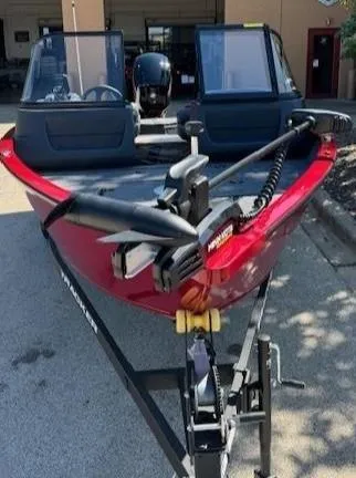Slide: The Image of 2025 Tracker Pro Guide V-16 WT boat in red, parked on a trailer. - 3