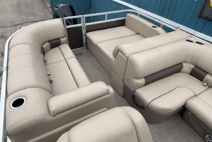 Slide: The Image of 2023 Sun Tracker Party Barge 22 RF XP3 interior with beige seating and cup holders. - 21