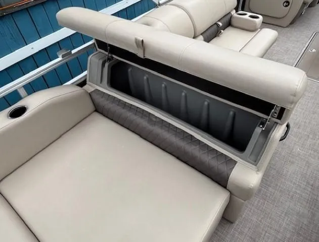 Slide: The Image of 2023 Sun Tracker Party Barge 22 RF XP3 with open storage compartment on beige seating. - 26
