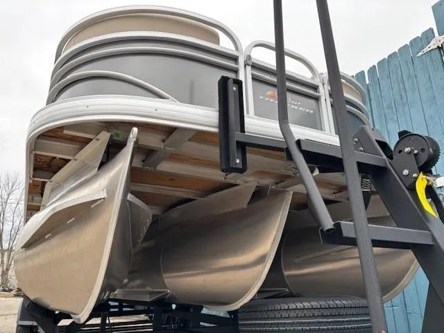 Slide: The Image of 2023 Sun Tracker Party Barge 22 RF XP3 pontoon boat on trailer, viewed from below. - 4